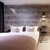 Dorint Resort Winterberg room with king bed, wood-paneled accent wall and standing lamp in Winterberg
