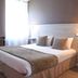Hôtel L'Europe in Cholet guest room with double bed, bedside lamps and bright window