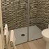 Trigrana Vacanze Hotel in Castelluzzo bathroom with walk-in shower, mosaic tile walls, and toilet