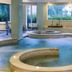 Rizzi Aquacharme Hotel & Spa in Darfo Boario Terme, indoor spa pool with curved whirlpool and lounge seating
