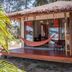 Baan Manali Resort in Ko Pha Ngan with a hammock on the porch of a thatched bungalow