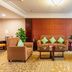 Tianheng International Hotel Jinhua lobby seating area with sofas, armchairs, coffee table and large windows