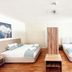 Zunfthaus zu Wirthen in Solothurn guest room with two beds, wood floors, and window light
