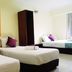 Sun Inns Hotel Kota Damansara Near Hospital Sungai Buloh guest room with three single beds and bright orange accent wall