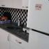 Cann Hotel Konakli kitchenette with checkered backsplash, sink, mini stove, fridge and washing machine