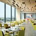 Four Points by Sheraton Surabaya, Tunjungan Plaza restaurant with city view and yellow chairs