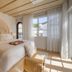 Donatella Boutique Hotel Miami Beach guest room with king bed, arched headboard and sunlit window