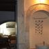 Vecchio Hotel, Rethymno: stone archway with hanging wall decor and a glimpse into a seating area