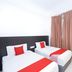 Kenyalang Suite Miri twin room with two single beds and beige curtains