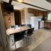 Denali RV Park and Motel in Healy kitchen area with dining table, stove, fridge and wood cabinets