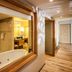 Hennessy Park Hotel in Ebene hallway with wood flooring and a bathroom window overlooking a soaking tub