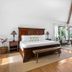 Mar Bella Boutique Hotel & Spa in Rehoboth Beach: bright bedroom with wooden bed, seating area, and balcony doors