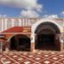 Cozumel Hotel & Resort in Cozumel with a tiled courtyard and arched entrance under a blue sky