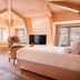 Beausite Zermatt in Zermatt: cozy attic suite with king bed, TV, seating area and mountain-view windows