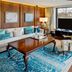 Hilton Frankfurt Gravenbruch suite with lake-view windows, seating area and balcony in Neu Isenburg