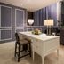 Hotel Pharos Seoul desk area with chair, table lamp, flowers and floor-to-ceiling curtains