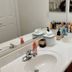 Happy Valley House Phoenix bathroom vanity with double sinks, mirror, and toiletries