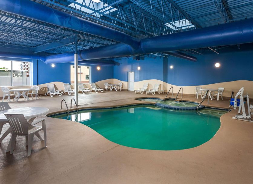 Wingate by Wyndham Sheboygan indoor pool with lounge chairs and blue ceiling