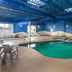 Wingate by Wyndham Sheboygan indoor pool with lounge chairs and blue ceiling