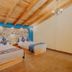Hotel Cielo y Selva in San Cristóbal de las Casas: rustic room with two beds and wood-beam ceiling