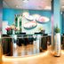 NYX Hotel Munich By Leonardo Hotels lobby reception with metallic desk and colorful wall art