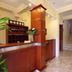 Hotel Stella di Mare in Bečići reception desk with wood paneling and marble floor beside stairway