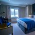 The Carpenters Arms Bristol guest room with king bed, window, and blue accent wall