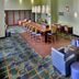 Hampton Inn & Suites Durham/North I-85 lobby with bar seating, lounge chairs and patterned carpet