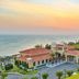 Centara Mirage Resort Mui Ne in Phan Thiet with seaside villas, palm trees and ocean sunset view