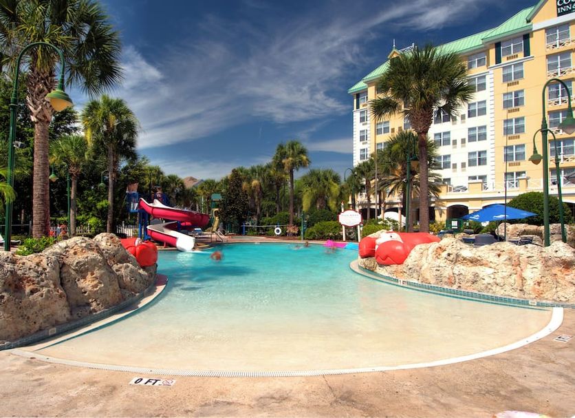 Calypso Cay Vacation Villas in Orlando with tropical pool, water slide and palm trees