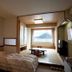 Toya Kohan Tei in Toyako: tatami room with futon, lake view window, and low table