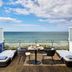 Le Grand Hôtel de Cabourg - MGallery Collection terrace with lounge chairs overlooking the sea in Cabourg
