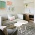 Hampton by Hilton Grand Cayman Seven Mile Beach living area with sofa, coffee tables and kitchenette in George Town