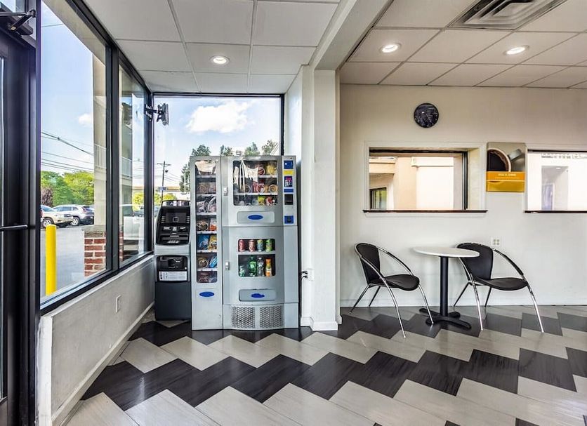 Motel 6 Elizabeth NJ Newark Liberty Intl Airport lobby with vending machines and seating by the entrance