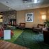 Fairfield Inn & Suites by Marriott Tupelo lobby with colorful seating, fireplace and patterned carpet