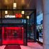 citizenM Austin Downtown hotel entrance with glowing red glass doors in Austin
