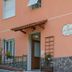 Al Riparo Affittacamere in Finale Ligure exterior with peach facade and stone base
