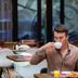 Boutique Hotel Corona in The Hague: guest drinking coffee at a hotel restaurant table
