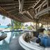 Conrad Bora Bora Nui in Vaitape: overwater restaurant with lagoon views and thatched roof seating