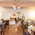 Logis Auberge La Cremaillere in Villandraut dining room with set tables and arched doorway