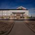 Holiday Inn Express & Suites Ada By IHG exterior entrance at dusk in Ada