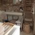 Mother Goose Hotel Utrecht bathroom with exposed brick wall, sink, mirror and rustic ladder shelf