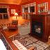 Kiwassa Lake Bed & Breakfast in Saranac Lake cozy lodge-style room with fireplace and wooden seating