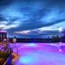 Hotel Il Gabbiano Beach in Terme Vigliatore features a lit rooftop pool with sea views at dusk