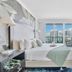 Miami Vacation Rentals - Coconut Grove bedroom with balcony and city skyline view in Miami