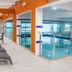 Hotel Vieira's in Balneário Camboriú indoor pool area with loungers and glass railings