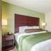 Cobblestone Hotel & Suites - Mccook room with king bed, nightstands and seating area in McCook
