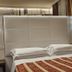 Hotel San Donato - Bologna centro guest room with a large bed, wall lamps, and patterned bedspread in Bologna.