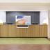 Spark By Hilton Evansville Downtown reception desk with green area rug and snack display in Evansville