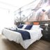CH La Bañezana Madrid guest room with double bed, desk and wall mural